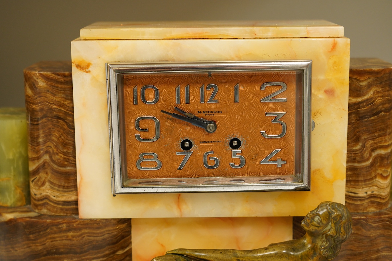 An Art Deco onyx and bronze figural clock, 27cm high. Condition - fair